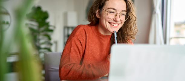 Smiling woman using laptop