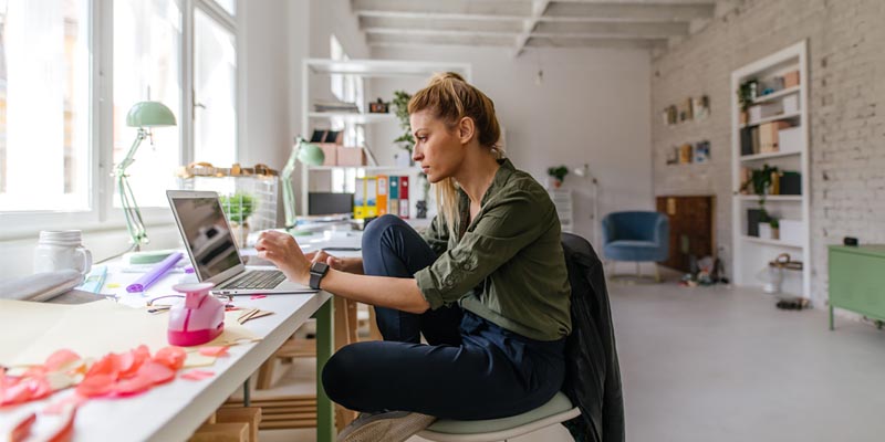 Designs - a woman relaxed working at computer